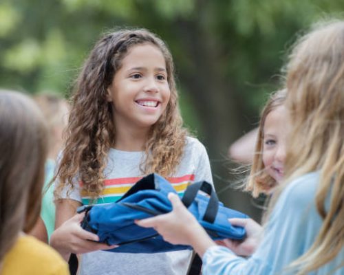 Children volunteering at school supply donation drive at elementary school